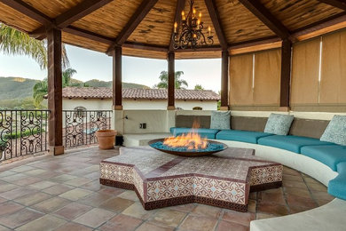 Design ideas for a large mediterranean shade backyard landscaping in San Luis Obispo with a fire pit.