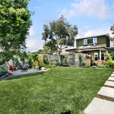 Photo of a mid-sized traditional full sun backyard concrete paver landscaping in Orange County.