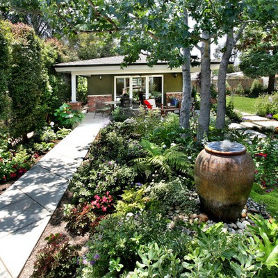 Inspiration for a large traditional partial sun backyard concrete paver landscaping in Orange County.