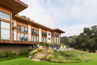 Large contemporary sloped full sun garden in San Francisco with natural stone paving.