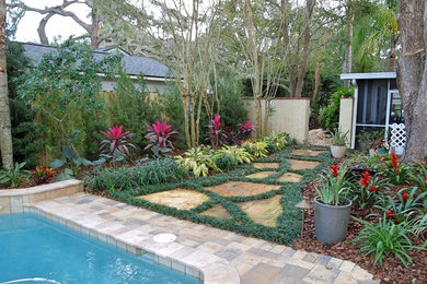Inspiration for a small contemporary shade backyard stone landscaping in Orlando for summer.