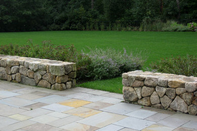 Photo of a large backyard stone landscaping in Boston.