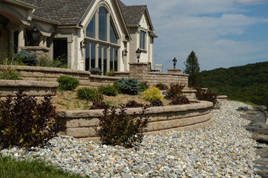 Photo of a large full sun backyard stone retaining wall landscape in New York.