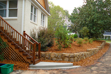 This is an example of a full sun side yard mulch retaining wall landscape in Atlanta.