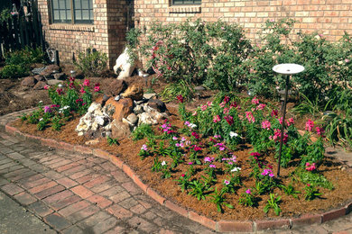 This is an example of a mid-sized transitional front yard brick formal garden in Orange County.