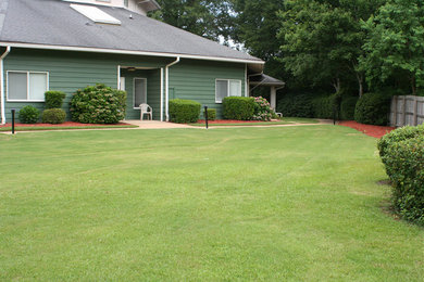 This is an example of a large full sun front yard landscaping in Other.