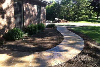 Photo of a medium sized traditional back formal partial sun garden for spring in Other with a garden path and natural stone paving.