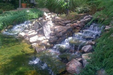 Photo of a large partial sun backyard landscaping in Little Rock.
