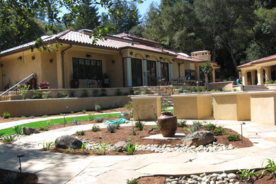 This is an example of a large mediterranean drought-tolerant backyard stone water fountain landscape in San Francisco.