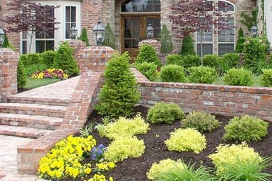 Design ideas for a full sun front yard brick landscaping in Toronto.