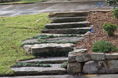 This is an example of a large traditional back partial sun garden in Little Rock with a garden path and natural stone paving.