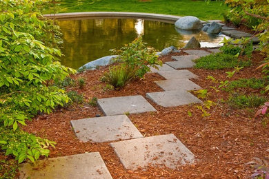 Inspiration for a large traditional partial sun backyard stone water fountain landscape in Boston.