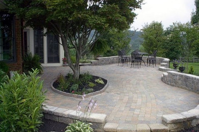 This is an example of a medium sized back partial sun garden in Other with natural stone paving.
