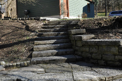 This is an example of a mid-sized backyard stone landscaping in Cincinnati.