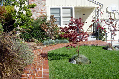 Photo of a small classic front driveway full sun garden in San Francisco with brick paving.