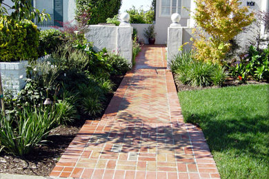 Inspiration for a small classic front driveway full sun garden in San Francisco with brick paving.