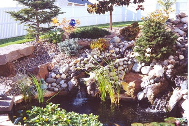 Inspiration for a mid-sized full sun backyard stone water fountain landscape in Seattle for spring.