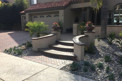 Design ideas for a mediterranean drought-tolerant front yard landscaping in Orange County.