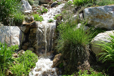 Inspiration for a mid-sized backyard stone water fountain landscape in Salt Lake City.