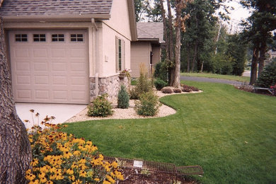 Design ideas for a large formal full sun garden in Minneapolis with natural stone paving.