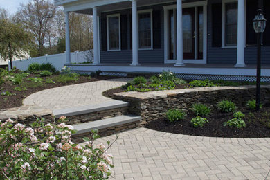 Photo of a large formal full sun garden in Boston with brick paving.