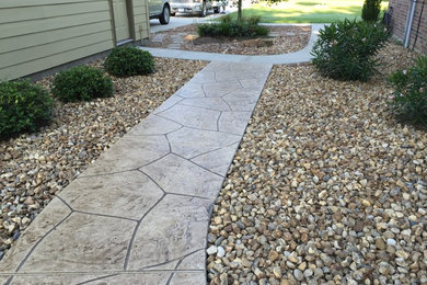 Photo of a mid-sized traditional partial sun side yard concrete paver garden path in Houston.