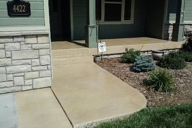 This is an example of a mid-sized full sun front yard concrete paver garden path in Columbus.