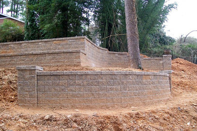 Inspiration for a mid-sized full sun backyard stone retaining wall landscape in Atlanta.