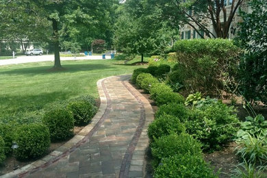 Design ideas for a large traditional front garden in Other with brick paving.