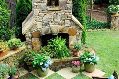 This is an example of a backyard stone landscaping in Atlanta with a fire pit.