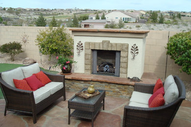 Design ideas for a rustic drought-tolerant and full sun backyard stone landscaping in Las Vegas with a fire pit.