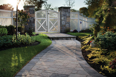 This is an example of a large traditional front yard stone landscaping in Other.