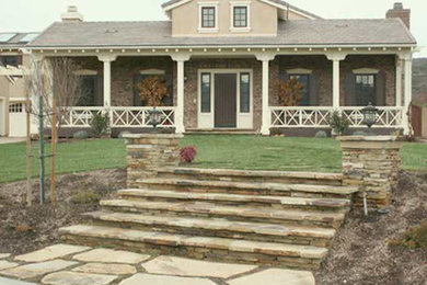 This is an example of a medium sized traditional front full sun garden in Austin with a garden path and natural stone paving.