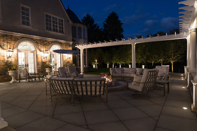 Inspiration for a huge backyard patio remodel in Philadelphia with a fire pit