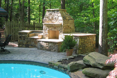 Inspiration for a large shade backyard stone landscaping in Atlanta with a fire pit.
