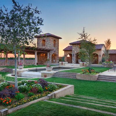 Inspiration for a huge mediterranean full sun backyard stone water fountain landscape in Other for summer.