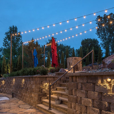 This is an example of a rustic backyard retaining wall landscape in Omaha.