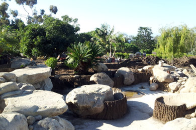 Photo of a huge tropical full sun backyard water fountain landscape in Santa Barbara.