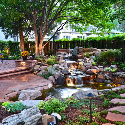 Inspiration for a traditional backyard stone waterfall in Denver.