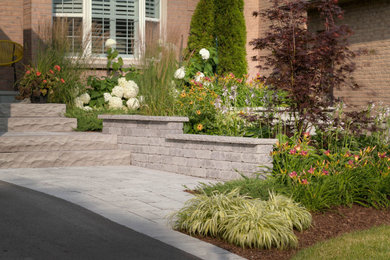 Photo of a mid-sized contemporary front yard concrete paver walkway in Toronto.