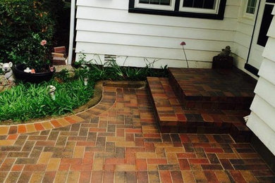This is an example of a medium sized classic back partial sun garden for summer in Chicago with natural stone paving.