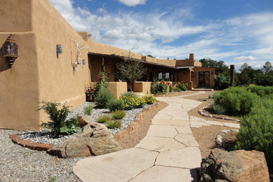 This is an example of a southwestern drought-tolerant and full sun front yard stone garden path in Albuquerque for summer.