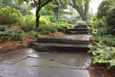 Photo of a traditional partial sun front yard stone garden path in New York.