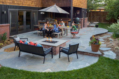 Patio - mid-sized eclectic backyard stone patio idea in Other with a fire pit