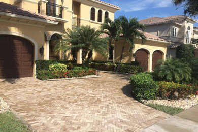 Modelo de acceso privado mediterráneo grande en patio delantero con exposición total al sol y adoquines de piedra natural