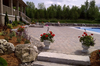 Inspiration for a large full sun stone landscaping in Toronto.