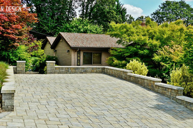 Large front driveway full sun garden in Portland with brick paving.