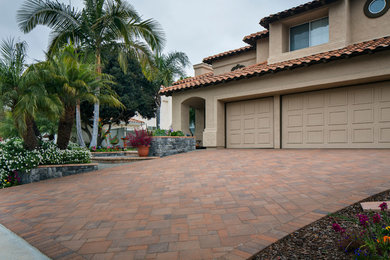 Inspiration for a mid-sized contemporary full sun front yard brick landscaping in San Diego.