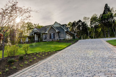 Inspiration for a huge craftsman side yard stone driveway in Other.