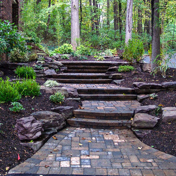 Paver front walkway and steps through natural landscape